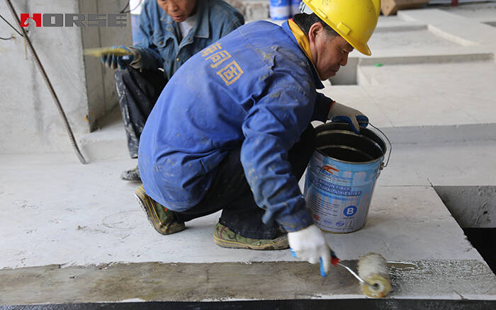Applying carbon fiber impregnating adhesive for CFRP strengthening Applying carbon fiber impregnating adhesive for CFRP strengthening